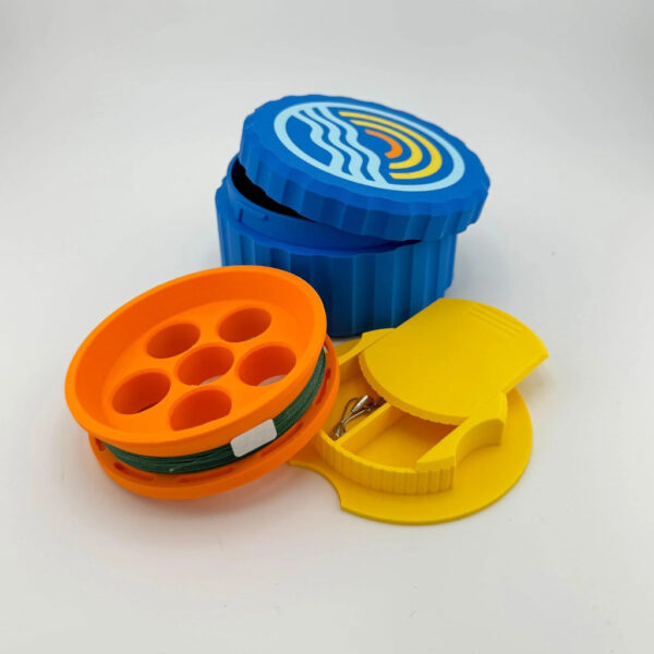 Compact hand reel survival fishing kit with colorful line spool and built-in tackle storage