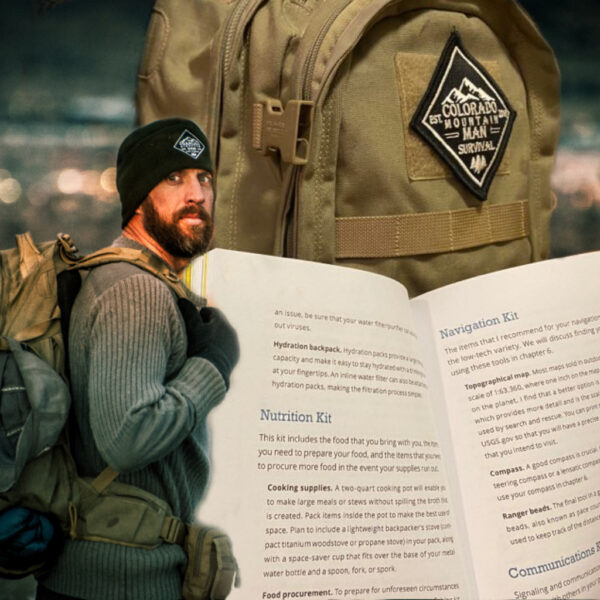 Jason Marsteiner wearing a beanie and backpack, standing outdoors with a copy of his Wilderness Survival Guide open to the Nutrition and Navigation Kit pages